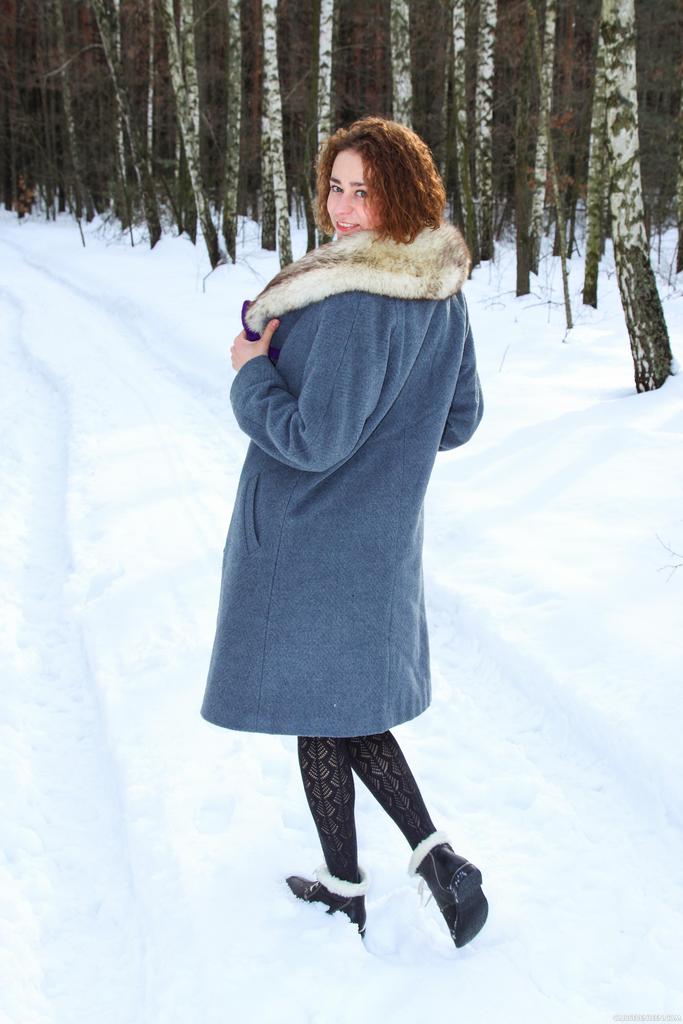 Petite teen girl Lola F strips naked on snow covered path next to the