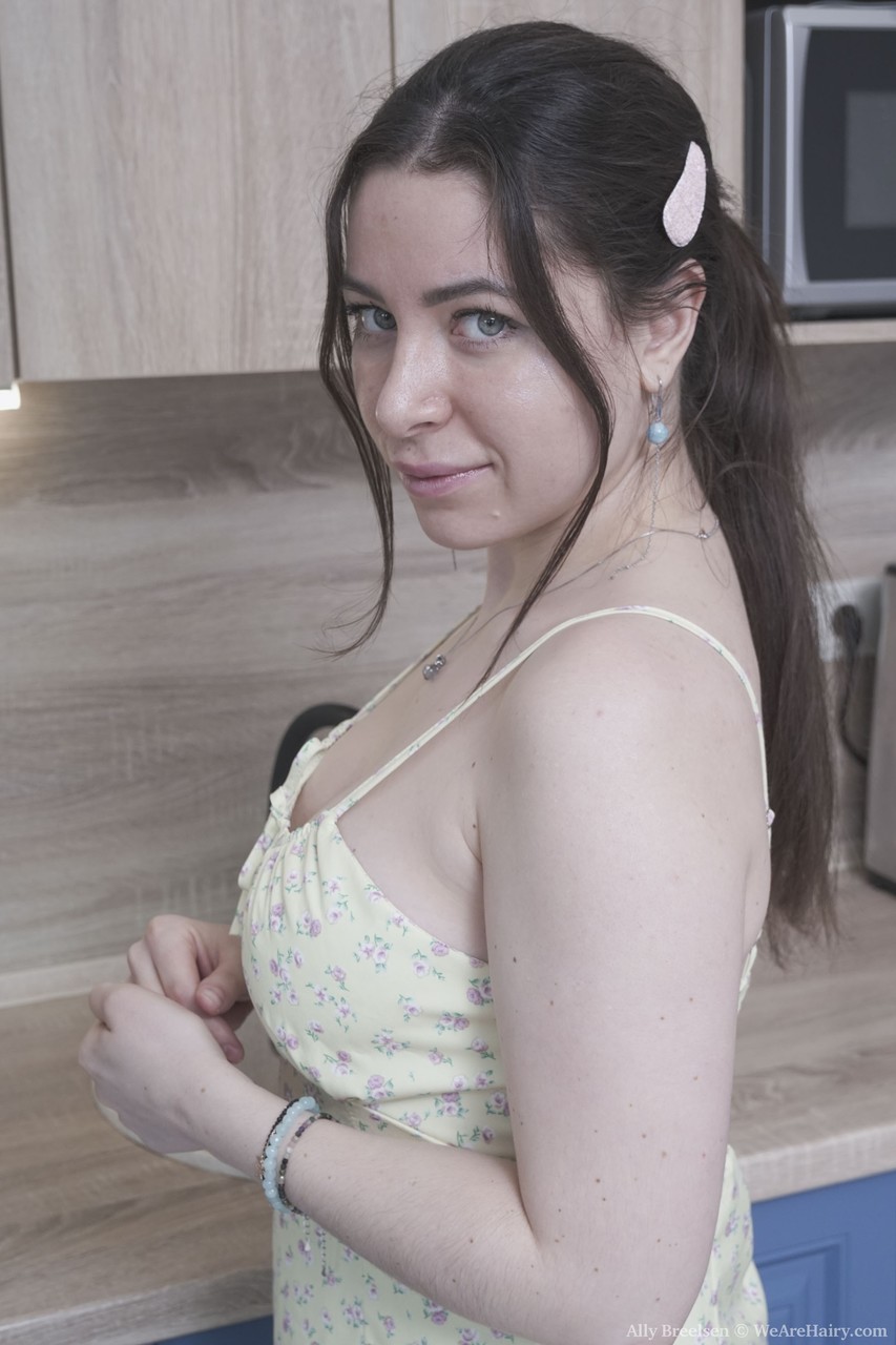 Brunette Russian Ally Breelsen strips in the kitchen and rubs her hairy twat