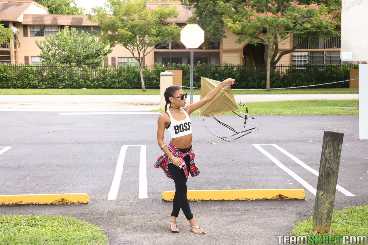 Beautiful skinny ebony babe Kendall Woods plays and flies a kite outside