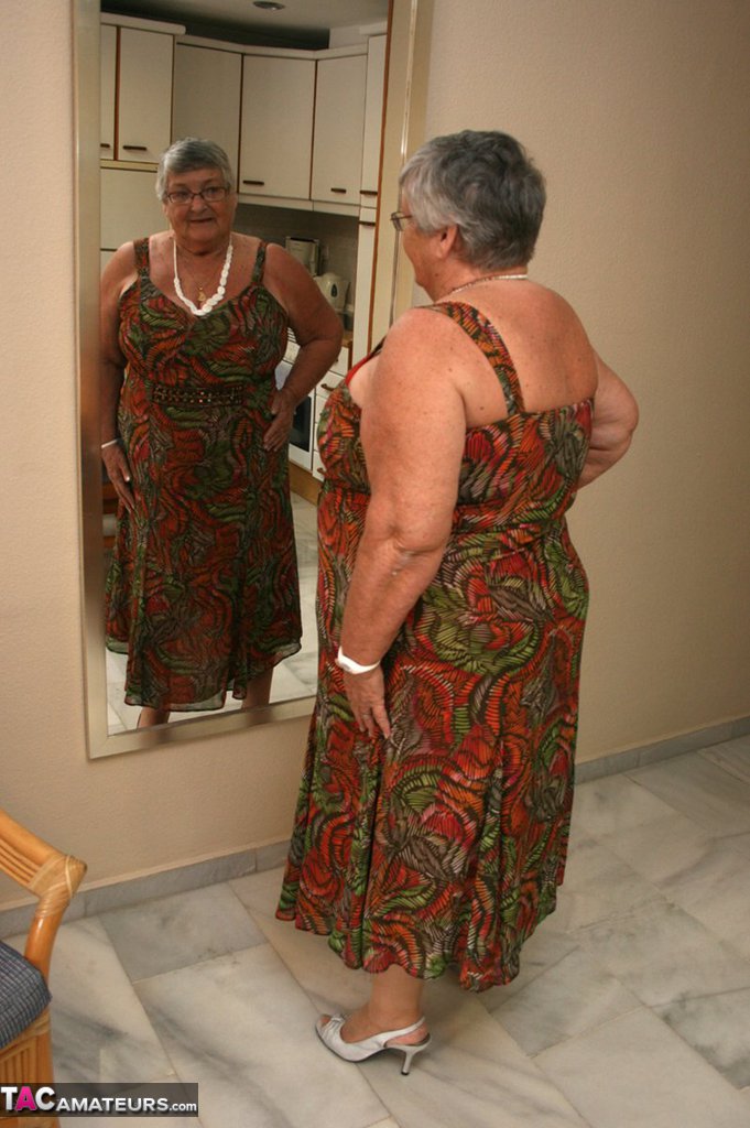 Silver haired granny Grandma Libby exposes her obese figure afore a mirror