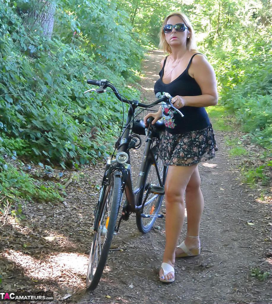 Busty plump mature Chrissy bicycling topless