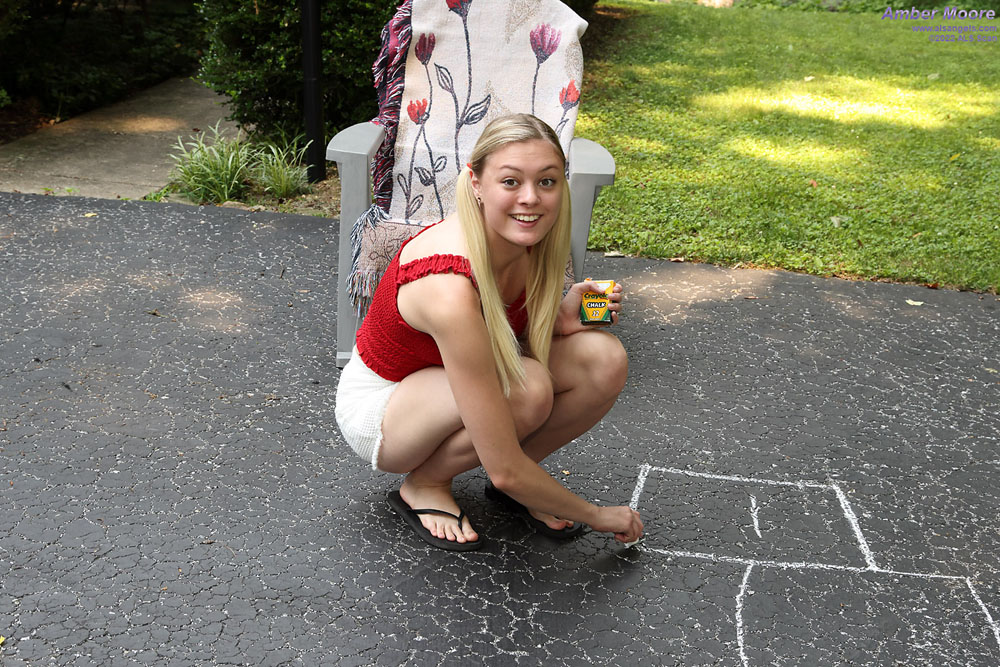 Young blonde Amber Moore pees on a driveway