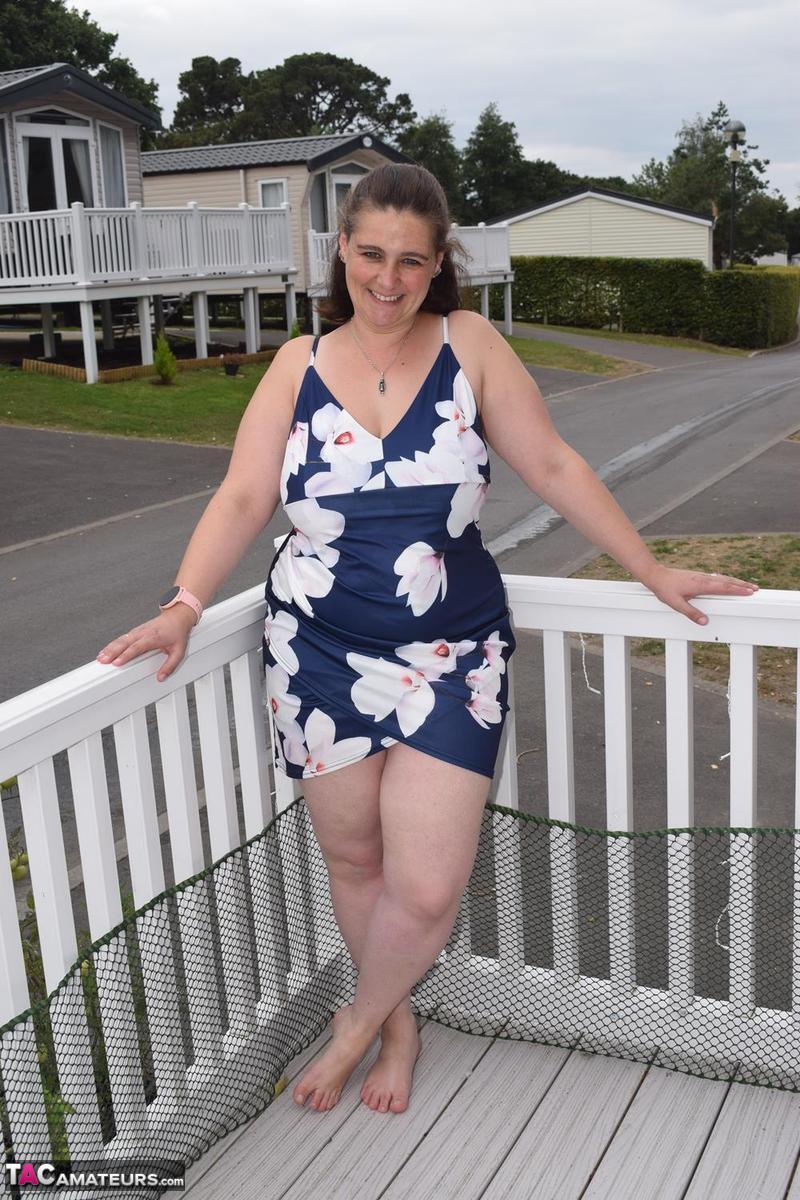 Middle-aged fatty exposes herself on a balcony in a public location