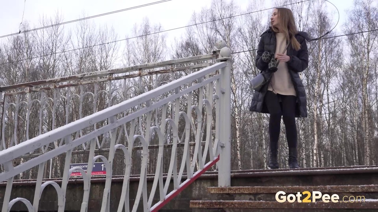 Caucasian female Valya takes a piss on snow-covered steps in public