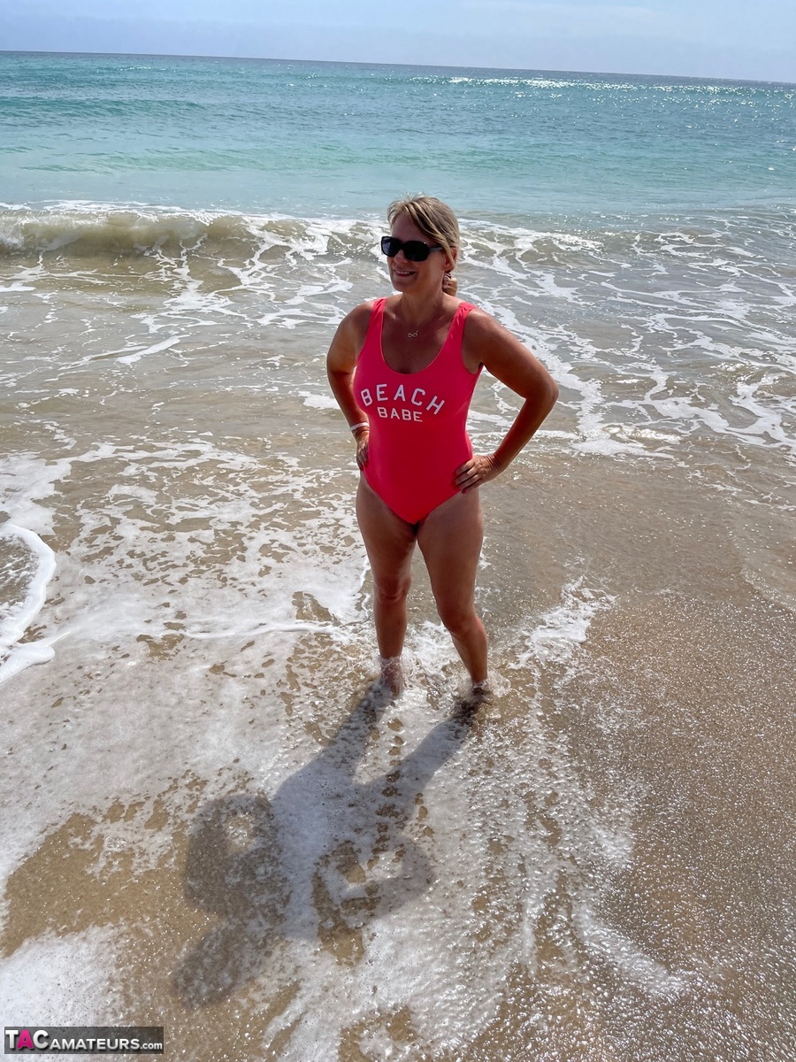Middle-aged blonde Sweet Susi gets totally naked on a sandy beach