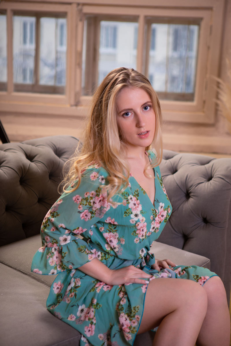 Blonde teen Lil Ivy removes a robe for confident nude poses on a sofa