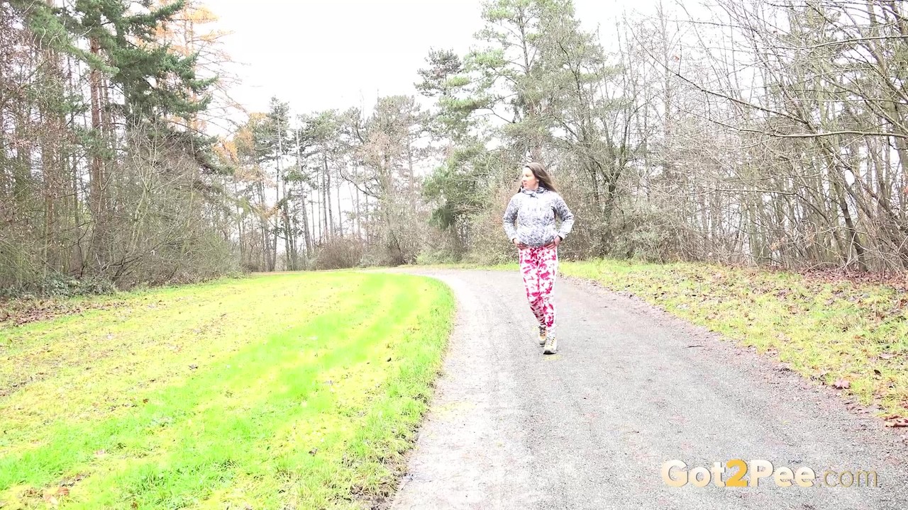 Solo girl Valentina Ross pulls down her leggings to take a pee on a rural road