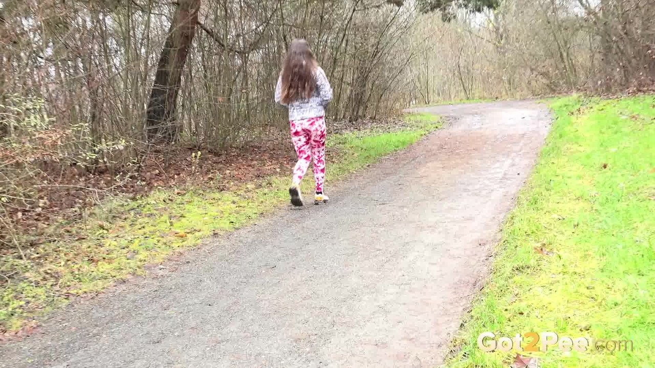 Solo girl Valentina Ross pulls down her leggings to take a pee on a rural road  