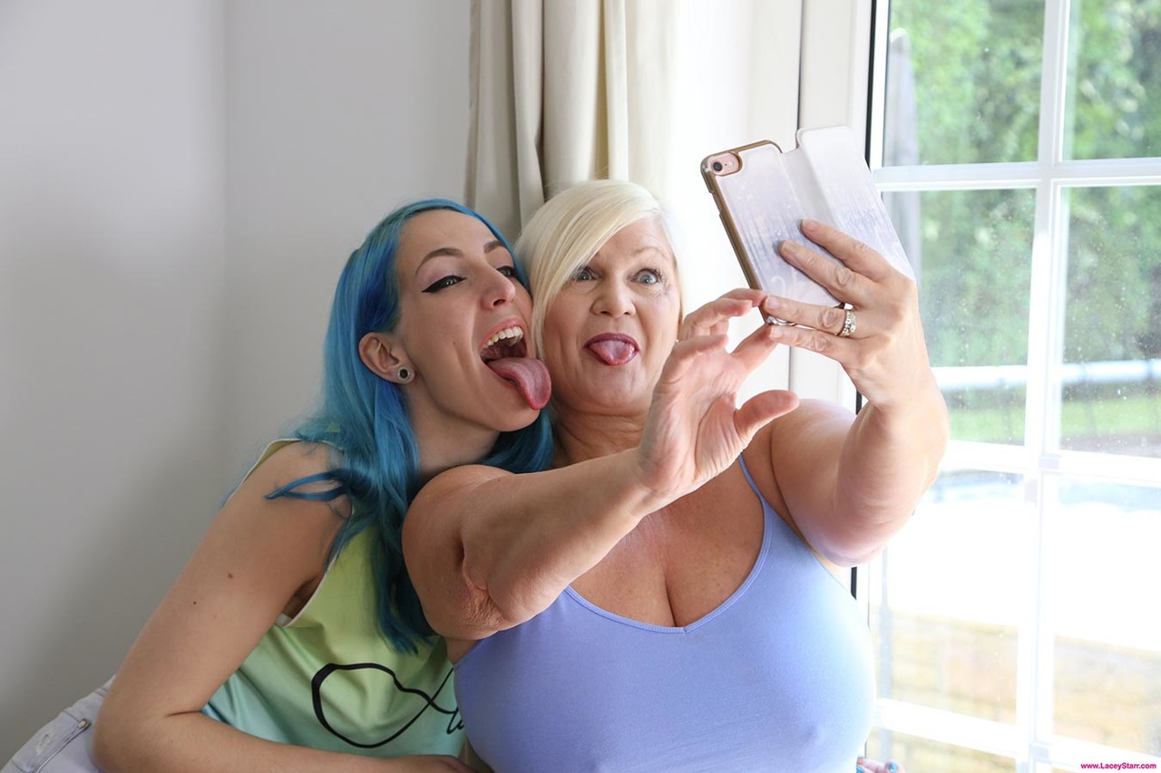 Older and younger lesbians Lacey Starr & Liz Rainbow take a selfie before sex