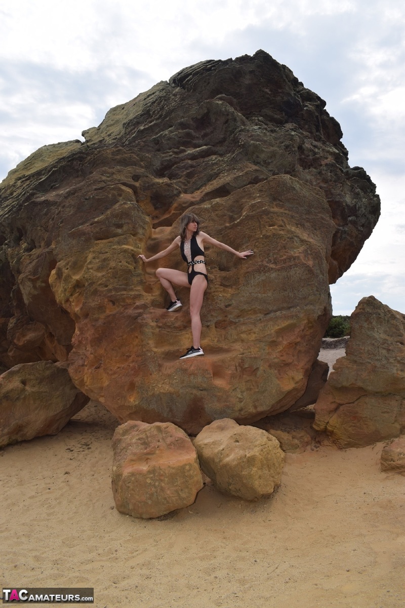 Amateur model gets naked in high-heeled footwear on iron ladened rocks