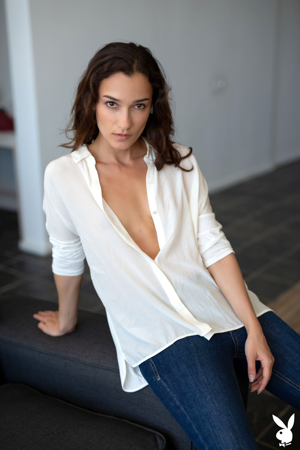 A Beauty Slipping Out Of Her Casual Jeans And White Blouse
