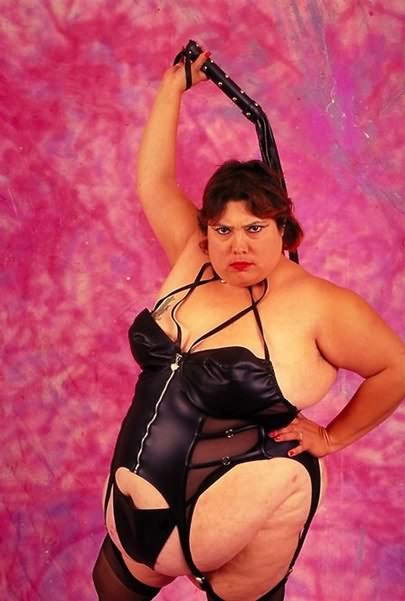 Dominatrix Looking Fat Chick Posing With Whip